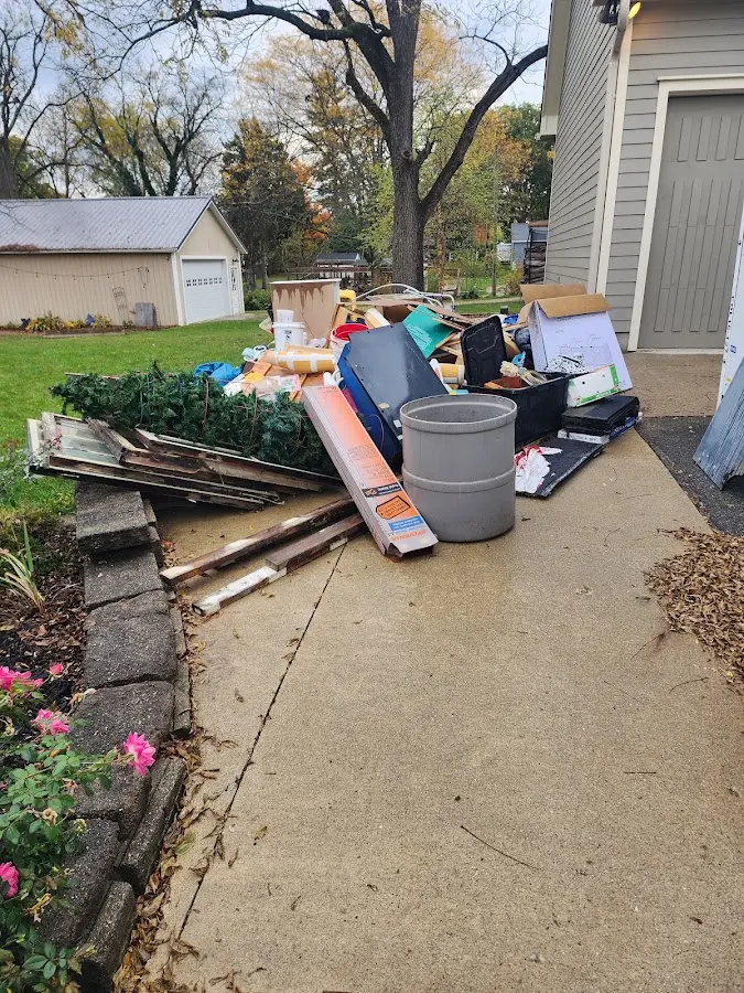 Dumpster being loaded with debris for Estate Cleanout Dumpster Rental in Elsa